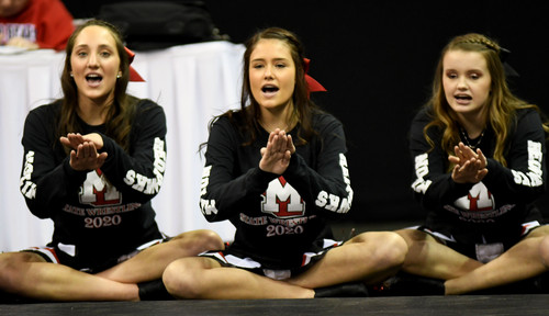 cheerleaders cheering on wrestling team