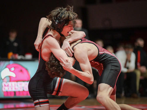 two wrestlers competing